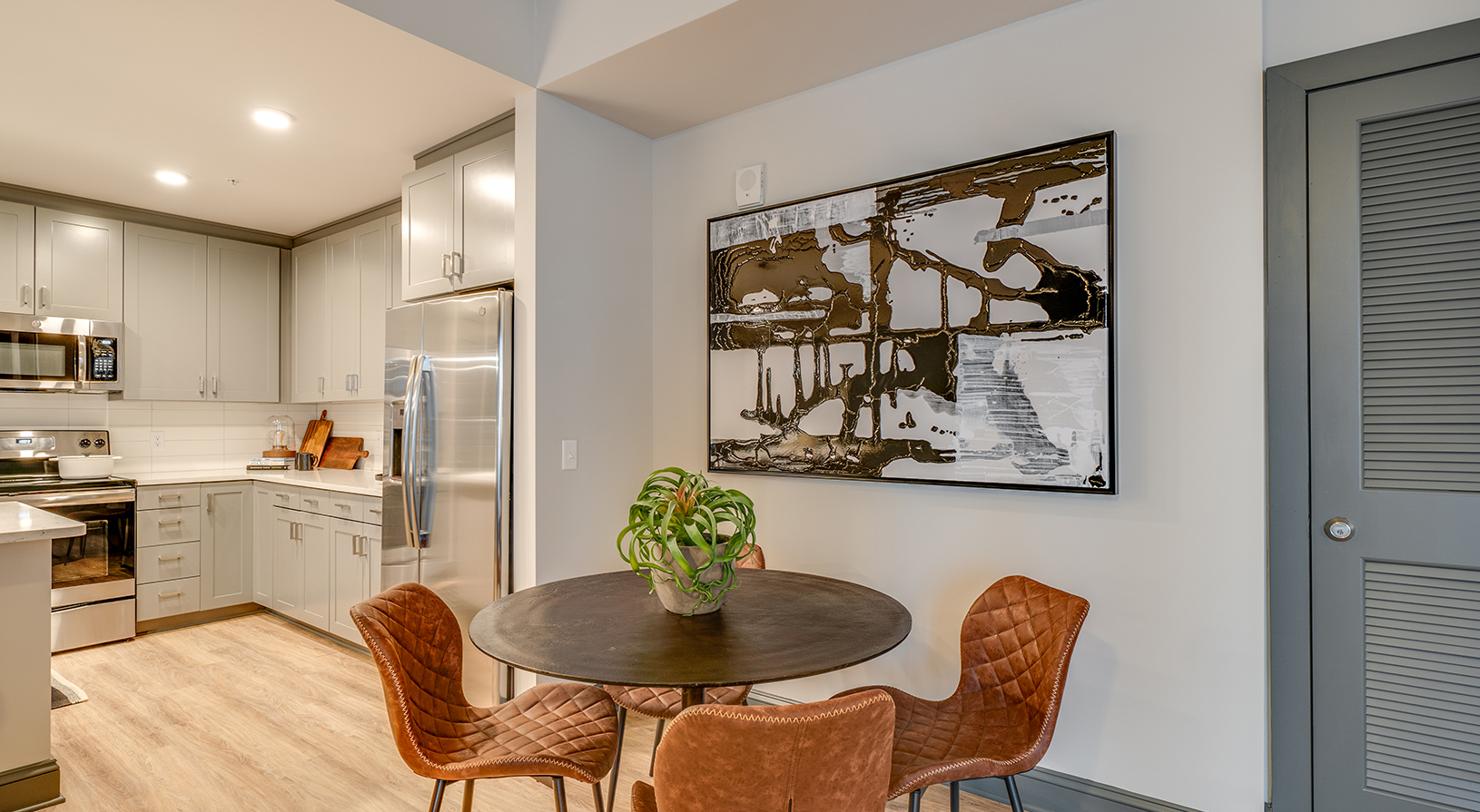 Peace Raleigh Apartments - Dining Area with large art piece