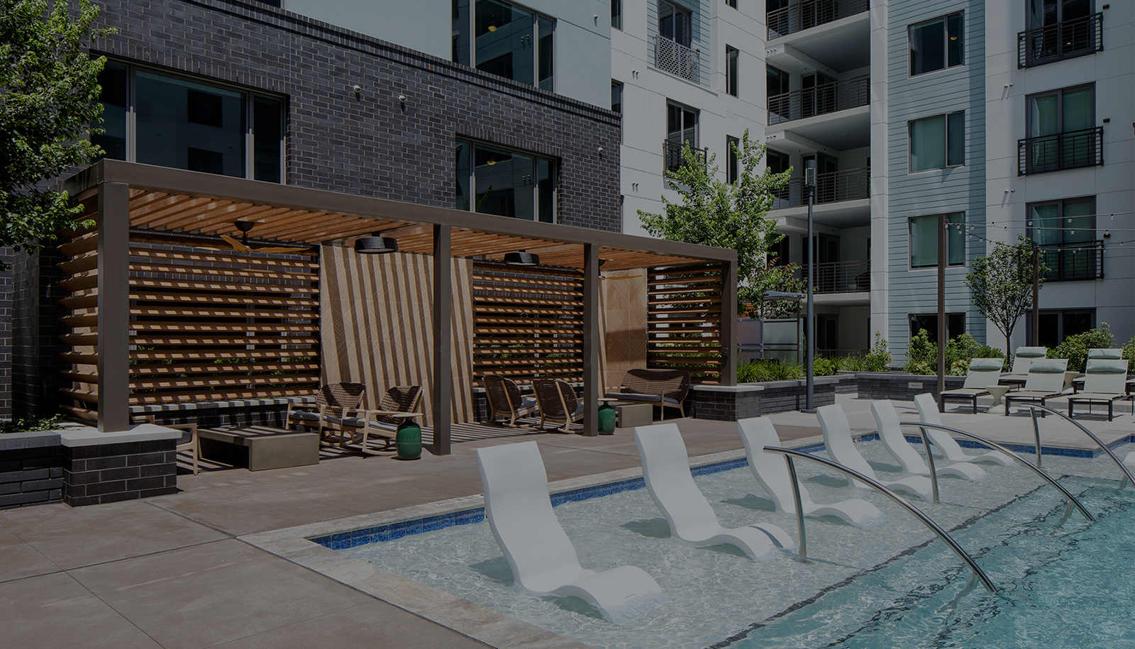 Peace Raleigh Apartments resort style pool with view of the cabanas and of the in-pool seating options